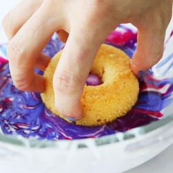 Dunking Shot of Donut into Glaze
